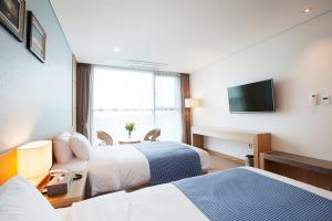 Postel nebo postele na pokoji v ubytování YOUUS Hotel