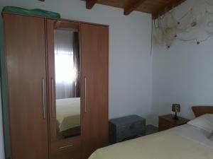 a bedroom with a wooden cabinet and a bed at Apartment Pomer 7374b in Pomer