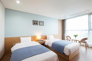 Postel nebo postele na pokoji v ubytování YOUUS Hotel