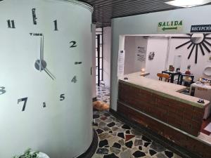 a large clock on the side of a building at Hotel Americano Plus in Pereira