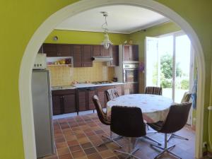 an archway in a kitchen with a table and chairs at Holiday Home in Plozévet near Beaches in Plozévet +21 photos