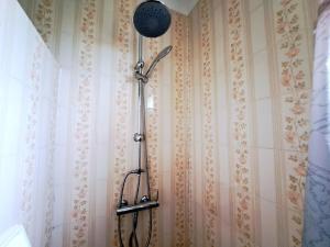 a shower in a bathroom with a shower head at Holiday Home in Plozévet near Beaches in Plozévet