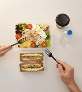 a table with a plate of food and two people holding forks at InstaHotel-MainBranch in Suwon +168 photos