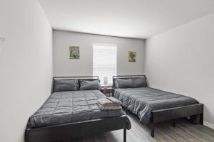 a bedroom with two beds and a window at Modern and Cozy Home in HTX in Houston