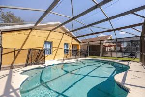a large swimming pool with a glass roof at Magical World in Davenport