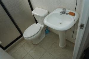 a bathroom with a toilet and a sink at Room in a shared apartment full of peace in Tonalá