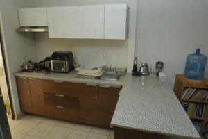 a kitchen with a sink and a counter top at Room in a shared apartment full of peace in Tonalá