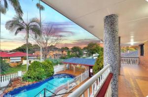 a view from the balcony of a house with a swimming pool at Mains Rd 超大4人带厨房卫浴办公 M1 in Brisbane