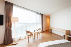 Postel nebo postele na pokoji v ubytování YOUUS Hotel