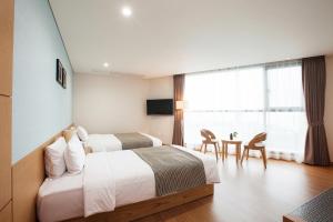 Postel nebo postele na pokoji v ubytování YOUUS Hotel