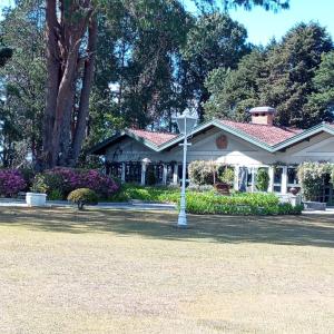 une maison avec un lampadaire devant dans l'établissement Vila dos Pinheiros, à Campos do Jordão