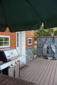 a grill and a smoker on a wooden deck at Rush River Cottage & Gardens in Ellsworth +3 photos