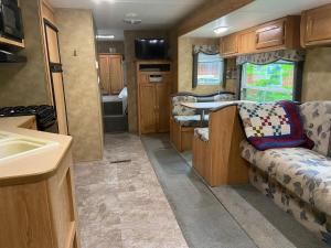 an rv kitchen with a couch and a sink at Rush River Cottage & Gardens in Ellsworth