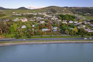 an aerial view of a home next to the water at Bangalow Bach in Nelson