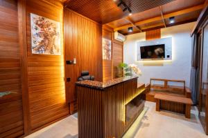 a hallway with wood paneled walls and a fireplace at Batur Volcano Guest House & Villa in Kintamani