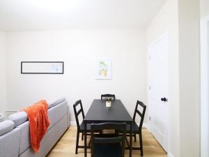 a dining room with a table and a couch at Cozy 1BR Getaway with Wifi - Mins to NYC in Paterson +1 photo