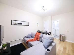 a living room with a couch and a table at Cozy 1BR Getaway with Wifi - Mins to NYC in Paterson