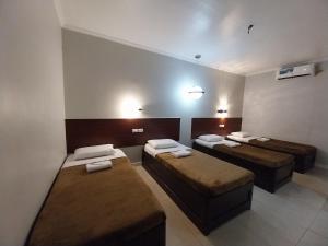 Ένα ή περισσότερα κρεβάτια σε δωμάτιο στο Wayfarer Pension House, Dormitory, and Fast Food