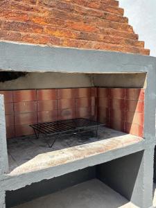 a brick wall with a bench next to a brick staircase at RoMa in Reconquista
