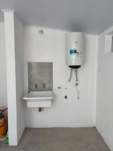 a white bathroom with a sink in the wall at RoMa in Reconquista +23 photos