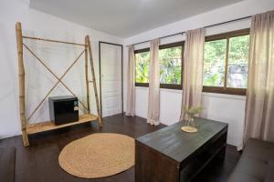 a living room with a table and a window at Baan Sawasdee Resort in Ko Lanta