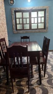 a wooden dining room table with chairs and a mirror at Casa Azul Jaraguá in São Sebastião
