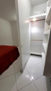 a small white room with a bed and a closet at Casa Azul Jaraguá in São Sebastião +26 photos