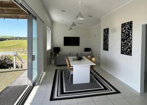 a living room with a table and a couch at The Shores Lakefront Retreat in Omamari