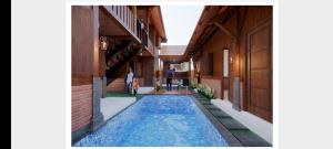 a swimming pool in the middle of a building at Ndalem Argupta in Kalibeber