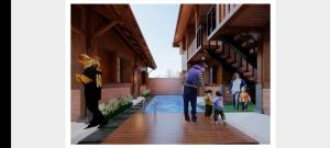 a rendering of a house with people walking down a sidewalk at Ndalem Argupta in Kalibeber