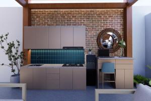 a kitchen with a stove and a brick wall at Ndalem Argupta in Kalibeber