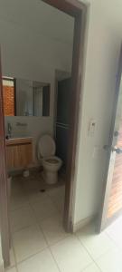 a bathroom with a toilet and a sink at Villa Campestre Eagle in Girardot +16 photos