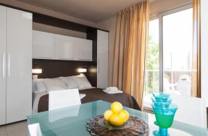 a bedroom with a bed and a table with fruit on it at Residence Sottovento in Rimini