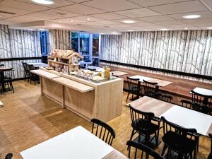 een restaurant met tafels en stoelen en een toonbank bij ibis Styles Caen Centre Historique in Caen