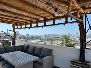 a living room with a couch and a table at Villa Yolanda in Acapulco