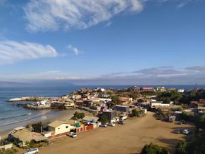 an aerial view of a small town next to the ocean at Cabaña entre eucaliptos en Huaquén 3D 1B más patio in Guaquen