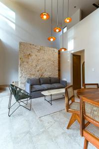 a living room with a couch and a table at Casa KakMo in Izamal