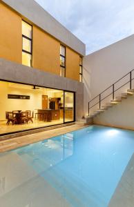 an empty swimming pool in front of a house at Casa KakMo in Izamal