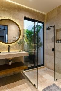 a bathroom with a sink and a mirror at Casa KakMo in Izamal