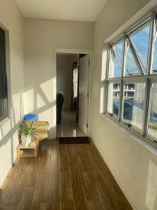 an empty room with a couch and windows at Bula Bliss Nadi - 2 Bedroom Apartment with Sunset View in Nadi