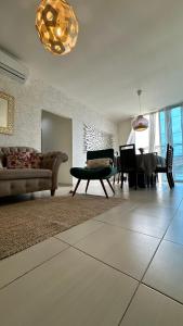 a living room with a couch and a table at APARTAMENTOS a una calle de la PLAYA Y MALECÓN SALINAS in Salinas