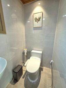 a bathroom with a white toilet and a sink at Yangyang 88 Hanok Stay in Yangyang