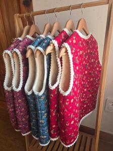 a row of boots and a red shirt on a rack at Yangyang 88 Hanok Stay in Yangyang