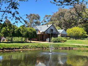a house with a pond in front of it at Elevation652 at Mt Bellevue in King Valley in Myrrhee