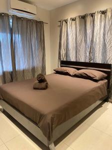 a bed with a teddy bear sitting on top of it at Bula Bliss Nadi - 2 Bedroom Apartment with Sunset View in Nadi +24 photos
