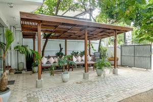 a pavilion with pillows and plants on a patio at Rise - Bed & Breakfast in Weligama