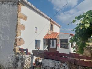 a white house with a window and a building at Casa da Tartaruga - Marvão in Santo António das Areias