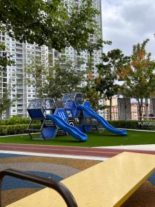 a playground in a park with a blue slide at Georgetown Urban Family & Baby-Friendly Home with Skypool Seaview in Jelutong