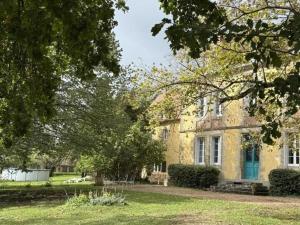 a large stone house with trees in front of it at Maison de maître XIXe avec piscine partagée et jardin à Gipcy - FR-1-489-504 in Gipcy