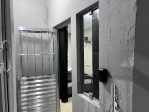 a door to a room with a mirror at Cantinho Fátima - Kitnet aconchegante próximo ao Santuário Nacional in Aparecida